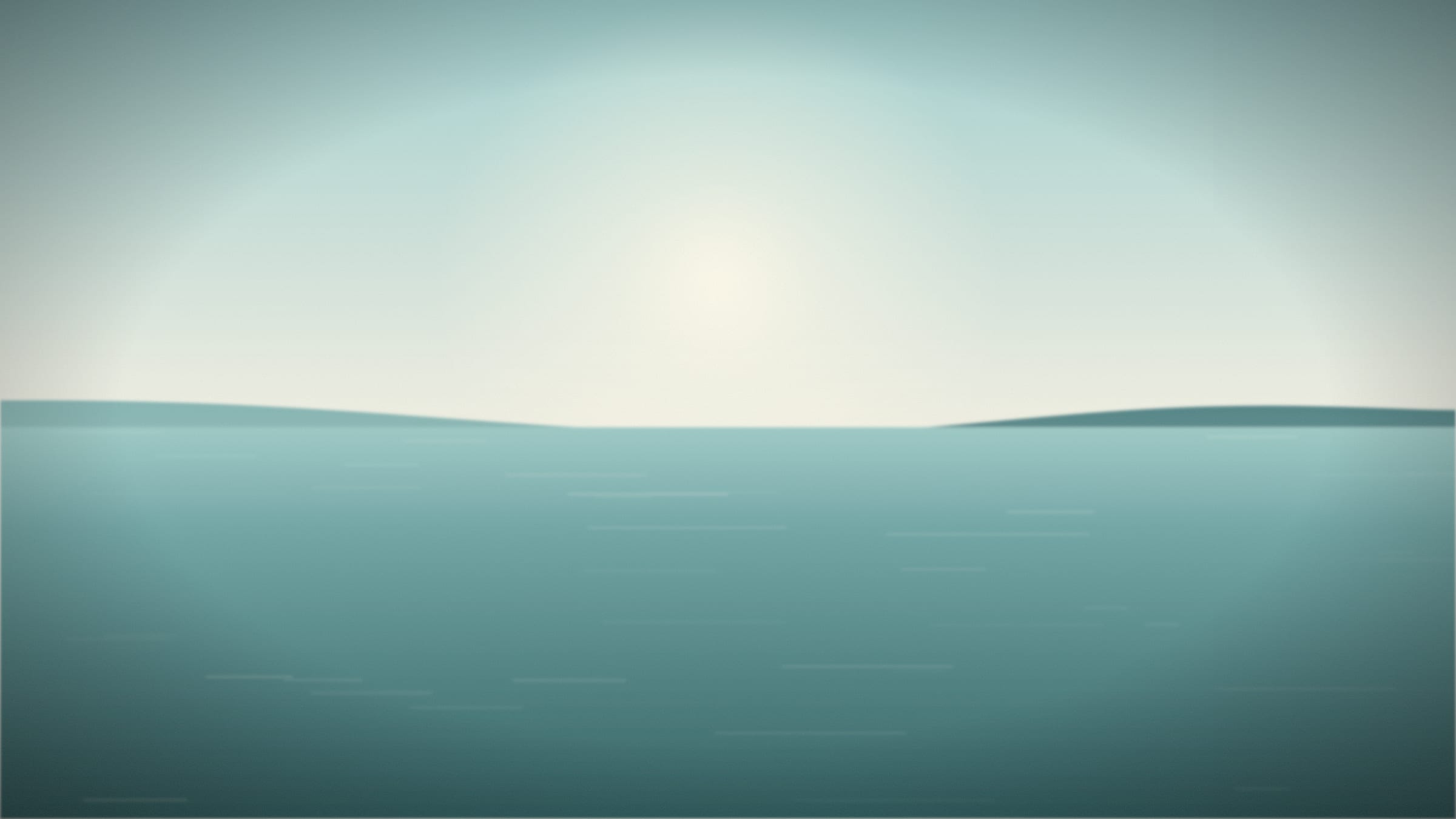 Turquoise water and a pale sky above a quiet shore